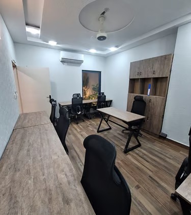 Furnished private office with wooden desks